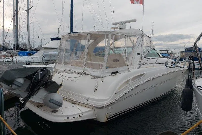 Slide: The Image of 2003 Sea Ray 360 Sundancer yacht docked in a marina, rear view. - 65