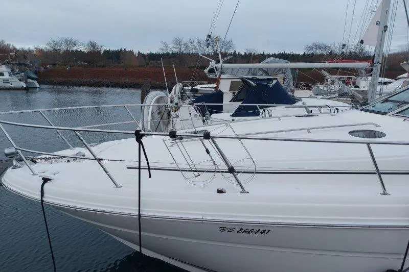 Slide: The Image of 2003 Sea Ray 360 Sundancer yacht docked in a marina, side view. - 8