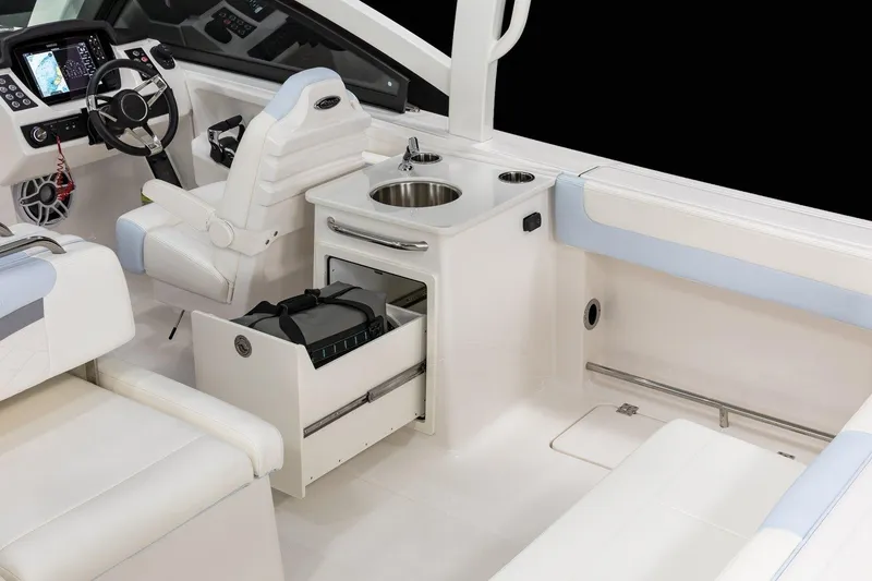 Slide: The Image of 2026 Robalo R257 Dual Console interior with helm, seating, and storage features. - 13