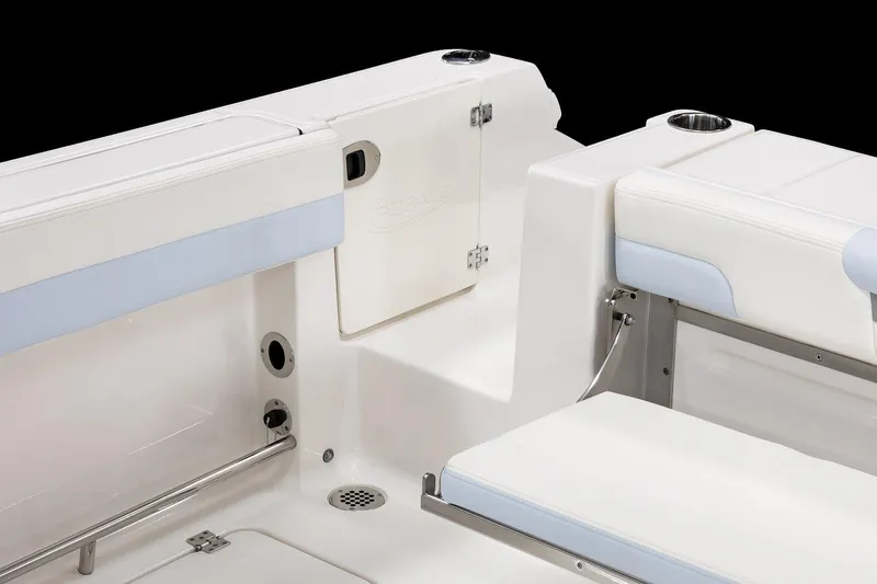 Slide: The Image of 2026 Robalo R257 Dual Console boat interior with white seating and cup holders. - 25