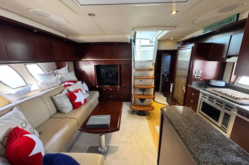 Slide: The Image of Luxurious interior of 2006 Sea Ray 48 Sundancer yacht with modern kitchen and cozy seating area. - 12