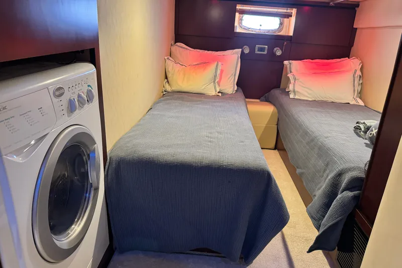 Slide: The Image of Interior of 2006 Sea Ray 48 Sundancer with twin beds and washing machine. - 18