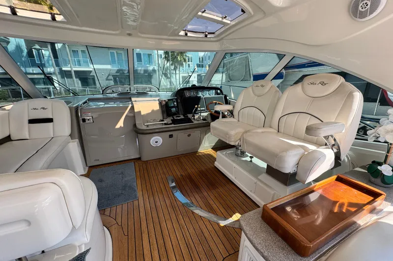 Slide: The Image of Luxurious 2006 Sea Ray 48 Sundancer yacht interior with plush seating and elegant wood flooring. - 22