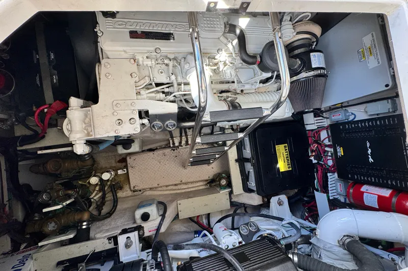 Slide: The Image of Engine compartment of a 2006 Sea Ray 48 Sundancer with Cummins engine and electrical components. - 25