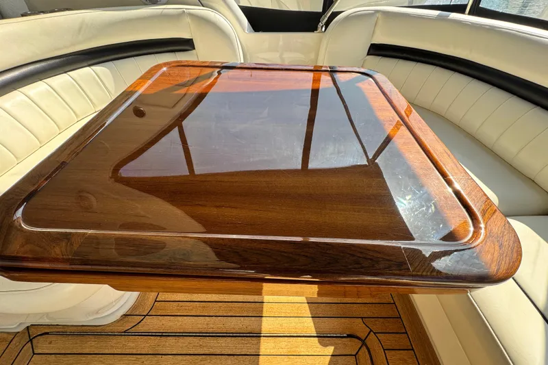 Slide: The Image of Luxurious interior of 2006 Sea Ray 48 Sundancer with polished wood table and leather seating. - 29