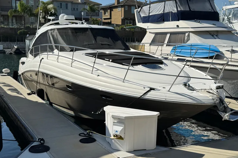 Slide: The Image of 2006 Sea Ray 48 Sundancer yacht docked at marina, featuring sleek design and modern amenities. - 3