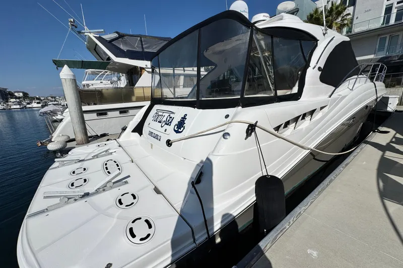 Slide: The Image of 2006 Sea Ray 48 Sundancer yacht docked at marina, featuring sleek design and spacious deck. - 35