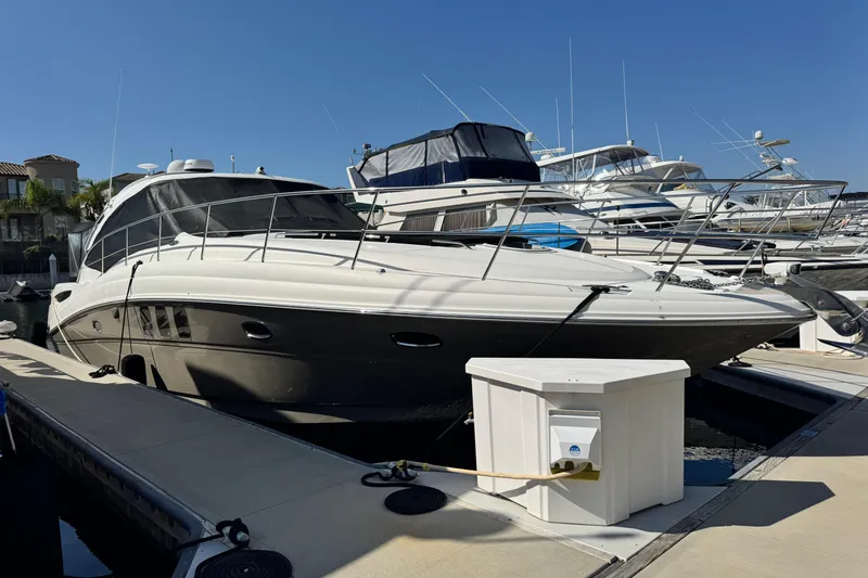 Slide: The Image of 2006 Sea Ray 48 Sundancer yacht docked at marina under clear blue sky. - 38