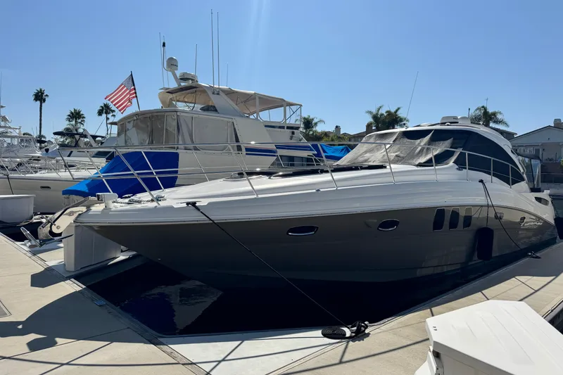 Slide: The Image of 2006 Sea Ray 48 Sundancer yacht docked at marina under clear blue sky. - 43