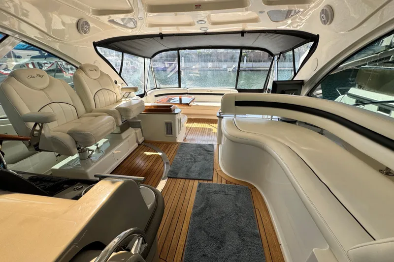 Slide: The Image of Luxurious interior of 2006 Sea Ray 48 Sundancer yacht with plush seating and wood flooring. - 7