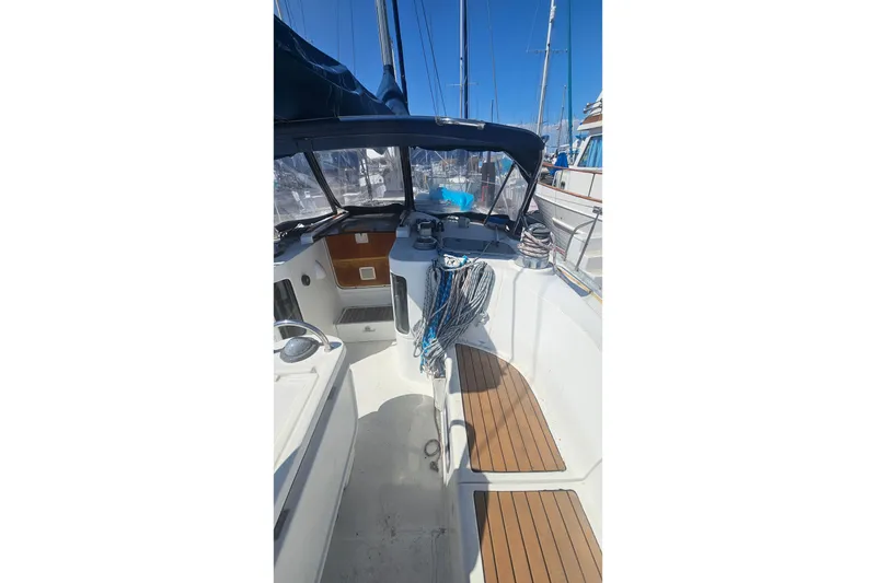 Slide: The Image of Cockpit of 1996 Beneteau Oceanis 440 sailboat with wooden seating and nautical equipment. - 12