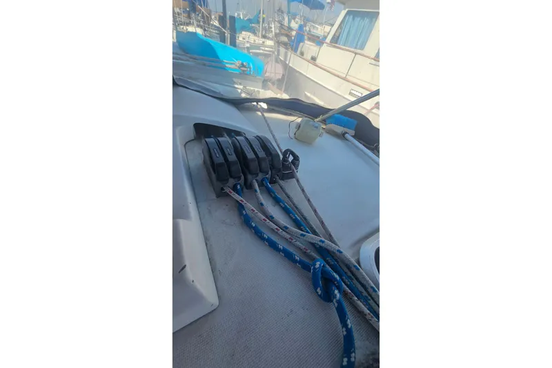 Slide: The Image of Deck of 1996 Beneteau Oceanis 440 sailboat with rope clutches and lines. - 14