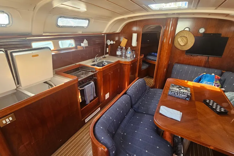Slide: The Image of Interior of 1996 Beneteau Oceanis 440 sailboat with kitchen and seating area. - 18