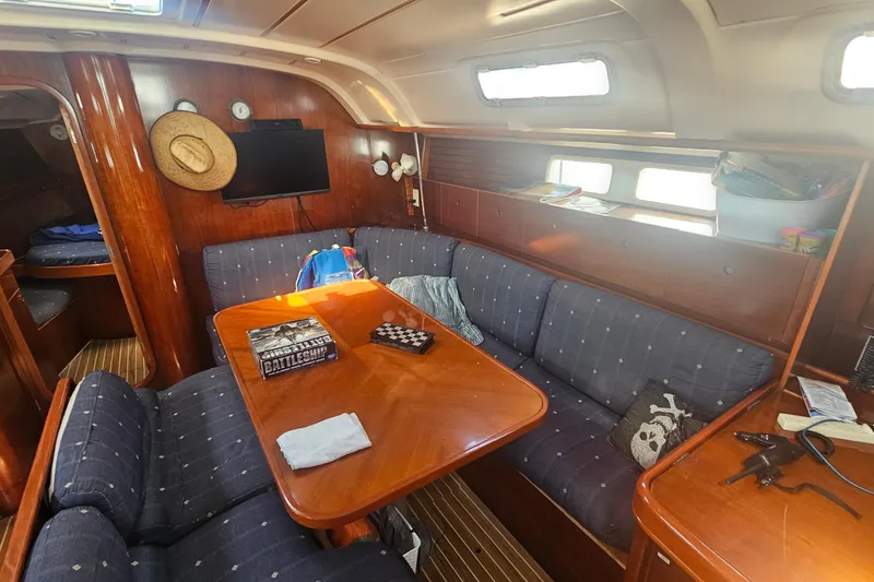 Slide: The Image of Cozy interior of 1996 Beneteau Oceanis 440 sailboat with wooden furnishings and seating area. - 19