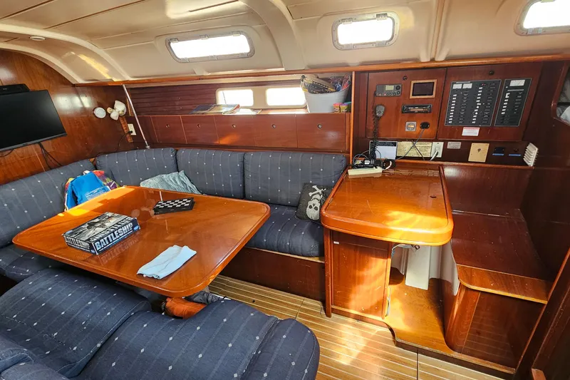 Slide: The Image of Cozy interior of 1996 Beneteau Oceanis 440 sailboat with wooden furnishings and seating area. - 21