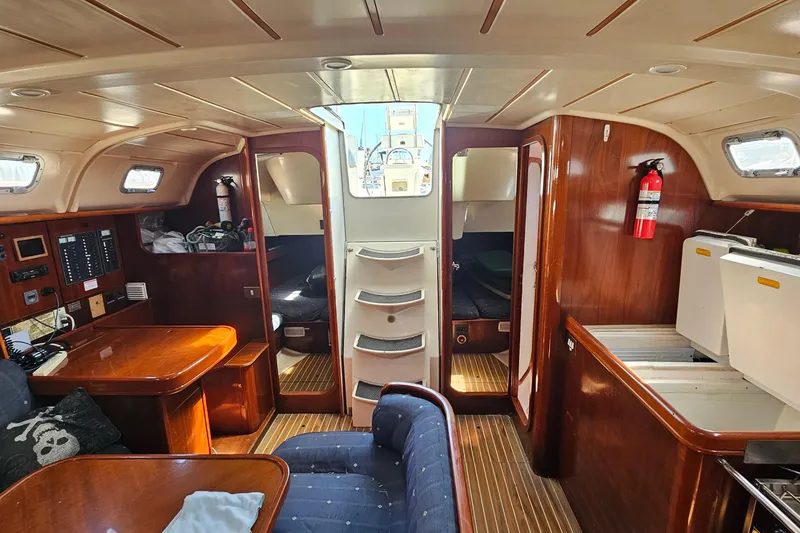 Slide: The Image of Interior of 1996 Beneteau Oceanis 440 sailboat with wood finish and seating area. - 23