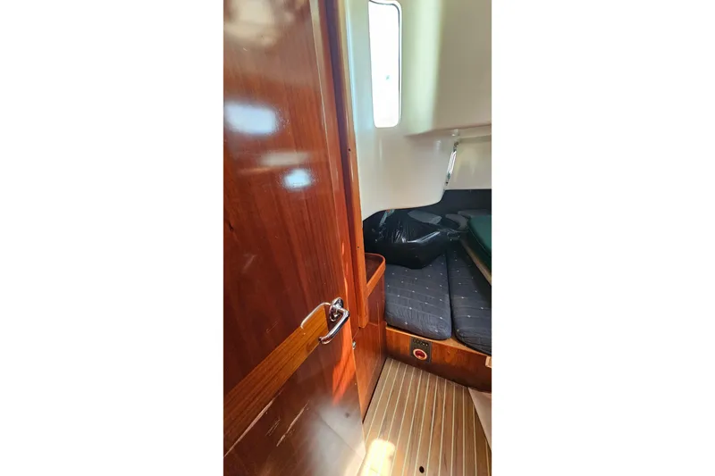 Slide: The Image of Interior cabin of 1996 Beneteau Oceanis 440 sailboat with wooden finish and cozy seating. - 27
