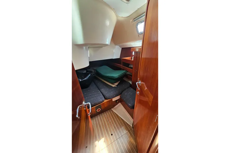 Slide: The Image of Interior cabin of 1996 Beneteau Oceanis 440 sailboat with wooden finish and cozy seating. - 29