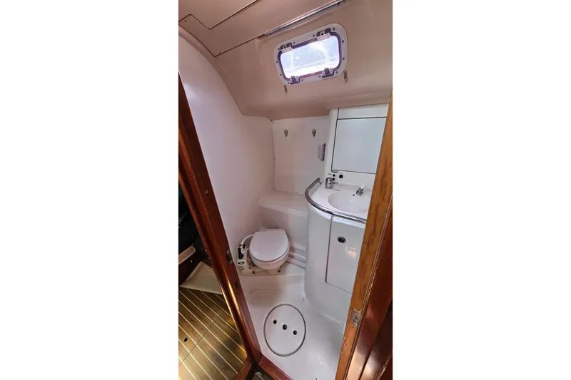 Slide: The Image of Bathroom interior of 1996 Beneteau Oceanis 440 yacht, featuring toilet and sink. - 30