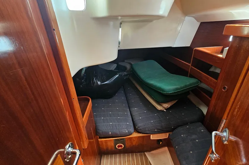 Slide: The Image of Interior cabin of 1996 Beneteau Oceanis 440 sailboat with wooden finish and cushions. - 32