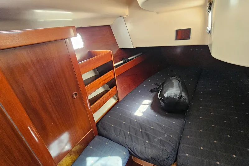 Slide: The Image of Interior cabin of 1996 Beneteau Oceanis 440 sailboat with wooden finish and cozy bedding. - 34