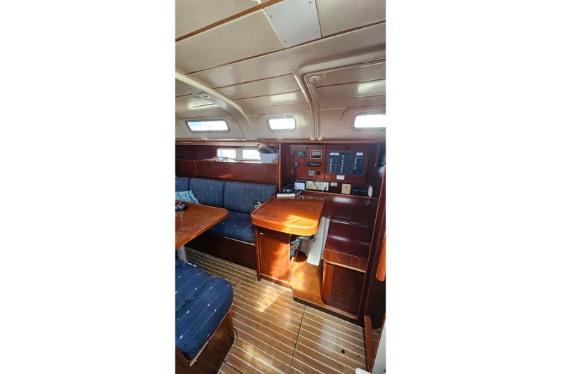 Slide: The Image of Interior of 1996 Beneteau Oceanis 440 sailboat with wood finish and seating area. - 35