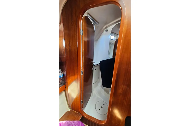 Slide: The Image of Interior view of 1996 Beneteau Oceanis 440 sailboat, featuring wooden door and cabin details. - 38