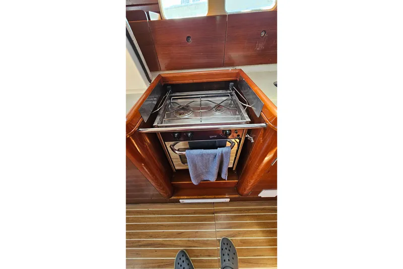 Slide: The Image of Galley stove in 1996 Beneteau Oceanis 440 yacht interior, featuring wooden cabinetry. - 41
