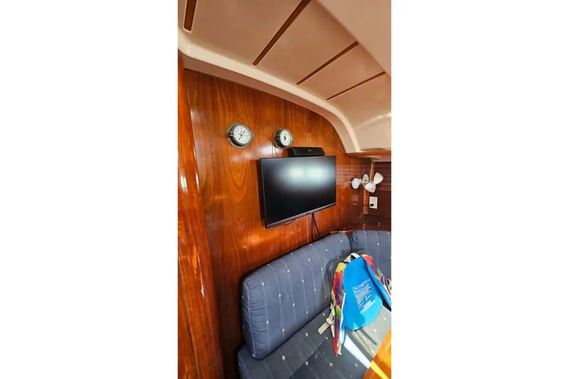 Slide: The Image of Interior of 1996 Beneteau Oceanis 440 yacht with wood paneling and mounted TV. - 42