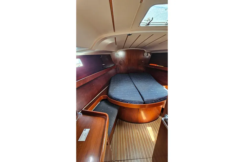 Slide: The Image of 1996 Beneteau Oceanis 440 cabin interior with wooden finish and cozy bed. - 46