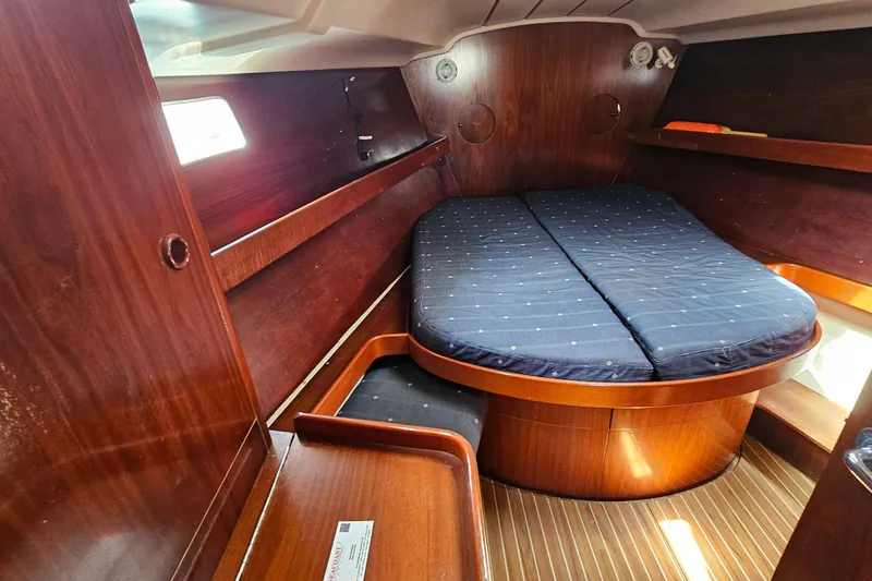 Slide: The Image of Cozy cabin interior of 1996 Beneteau Oceanis 440 sailboat with wooden finish and double bed. - 48