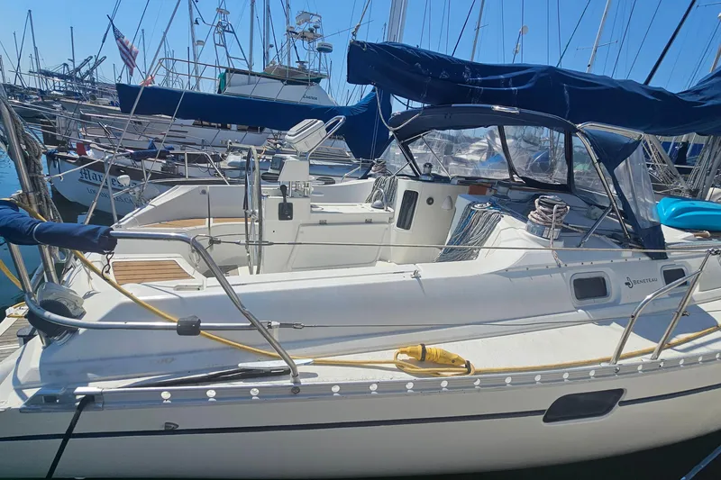 Slide: The Image of 1996 Beneteau Oceanis 440 sailboat docked in a marina, featuring sleek design and spacious deck. - 6
