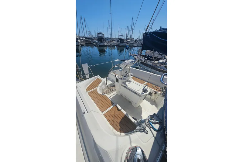 Slide: The Image of 1996 Beneteau Oceanis 440 sailboat cockpit with wooden deck, docked in marina. - 8