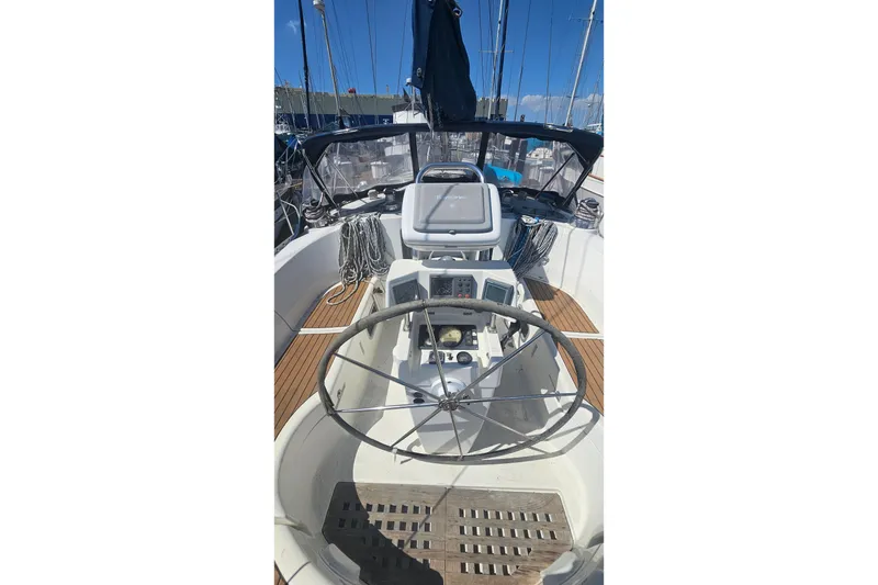 Slide: The Image of Cockpit view of 1996 Beneteau Oceanis 440 sailboat with steering wheel and navigation instruments. - 9