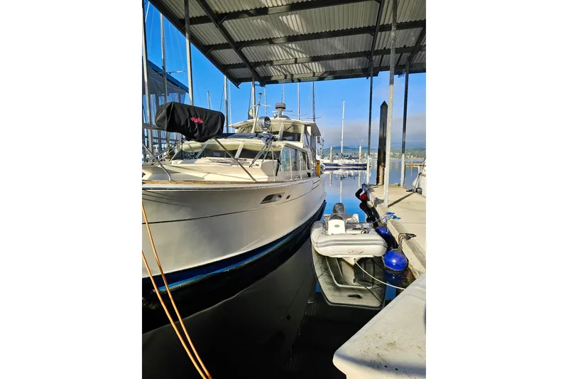 Slide: The Image of 1970 Chris-Craft Commander 42 yacht docked at marina under covered shelter. - 10