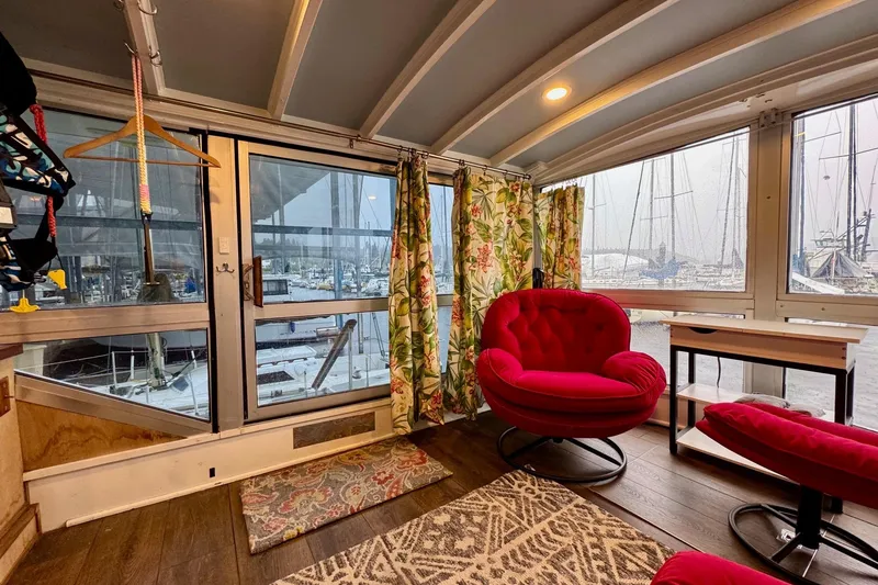 Slide: The Image of Interior of 1970 Chris-Craft Commander 42 with vibrant red chairs and marina view. - 15