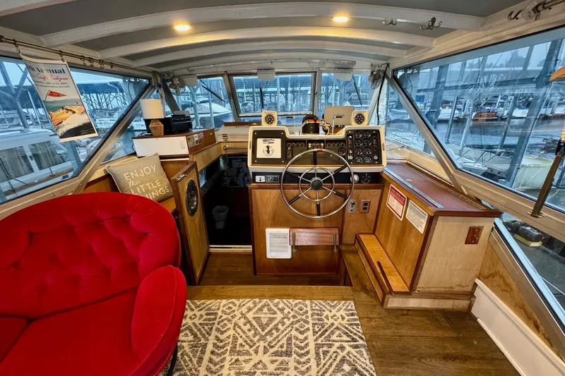 Slide: The Image of 1970 Chris-Craft Commander 42 boat interior with helm, red chair, and nautical decor. - 17