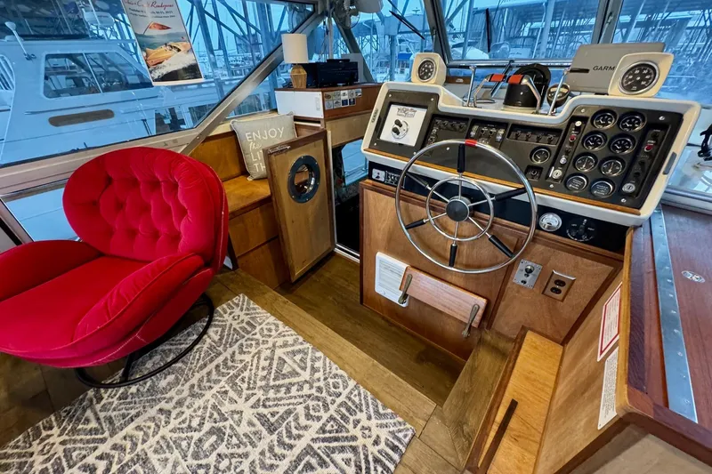 Slide: The Image of 1970 Chris-Craft Commander 42 helm with vintage controls, red chair, and nautical decor. - 18