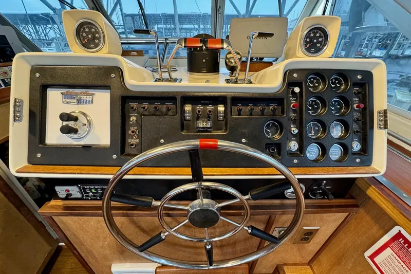 Slide: The Image of 1970 Chris-Craft Commander 42 helm with gauges, steering wheel, and controls. - 20