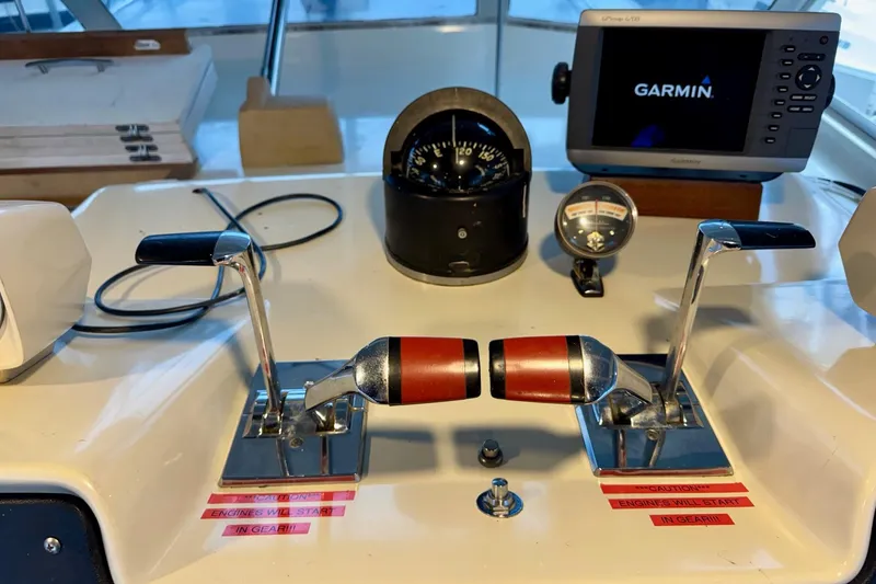 Slide: The Image of 1970 Chris-Craft Commander 42 helm with Garmin GPS, throttle controls, and compass. - 21