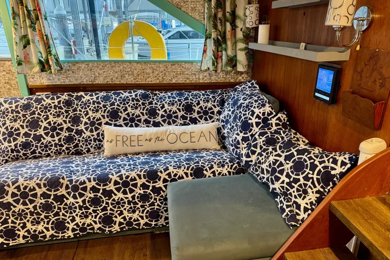 Slide: The Image of 1970 Chris-Craft Commander 42 interior with nautical-themed sofa and "Free as the Ocean" pillow. - 28