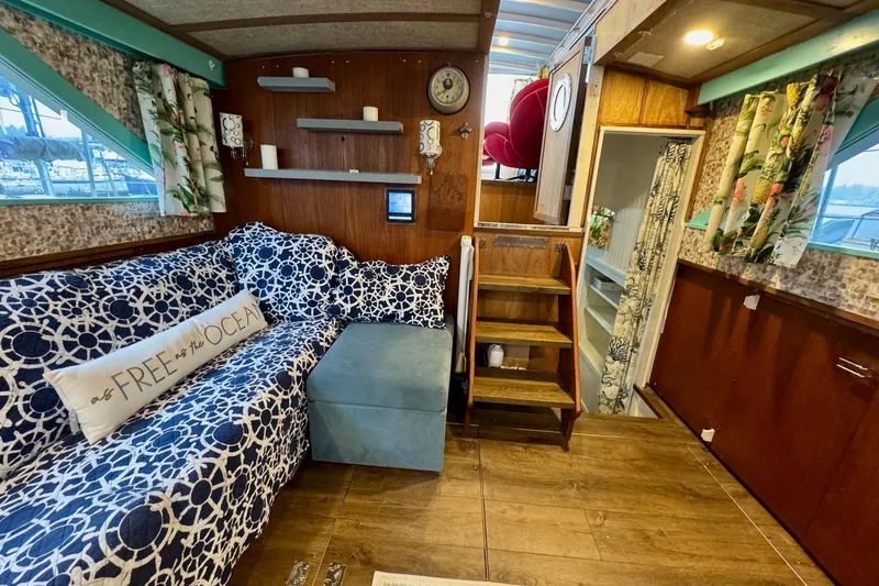 Slide: The Image of 1970 Chris-Craft Commander 42 interior with nautical decor, floral curtains, and wooden accents. - 29