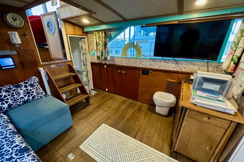 Slide: The Image of 1970 Chris-Craft Commander 42 interior with cozy seating, TV, and wooden decor. - 31