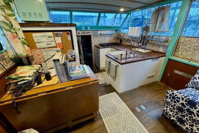 Slide: The Image of 1970 Chris-Craft Commander 42 interior with modern kitchen, wooden countertops, and nautical decor. - 34