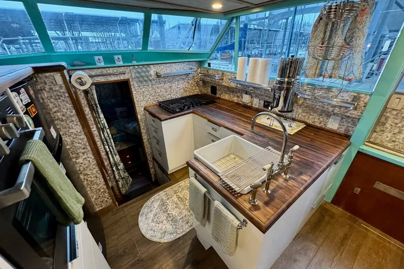 Slide: The Image of 1970 Chris-Craft Commander 42 kitchen with wood countertops and modern appliances. - 35