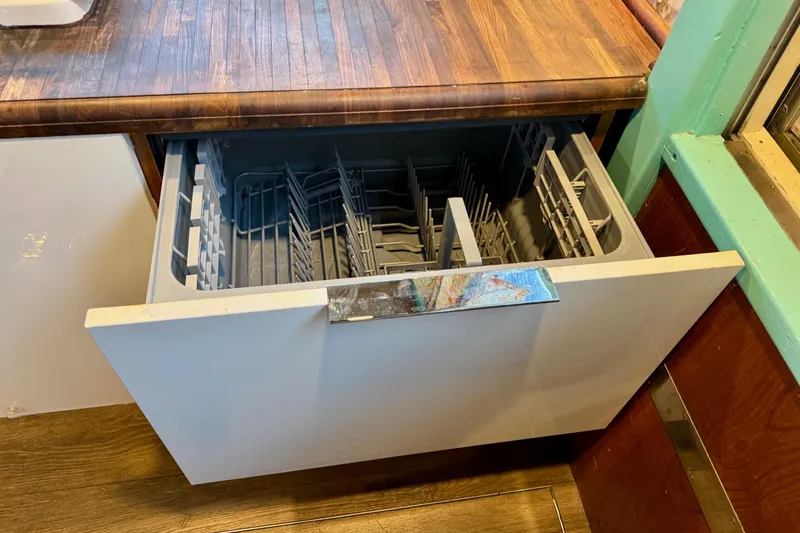Slide: The Image of Open dishwasher drawer in a 1970 Chris-Craft Commander 42 boat kitchen. - 36