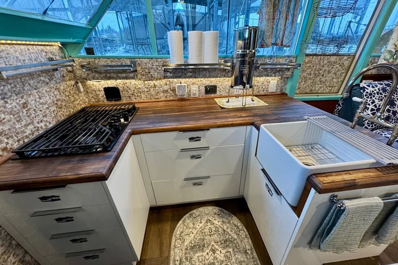 Slide: The Image of Vintage 1970 Chris-Craft Commander 42 kitchen with modern amenities and rustic wood countertops. - 37