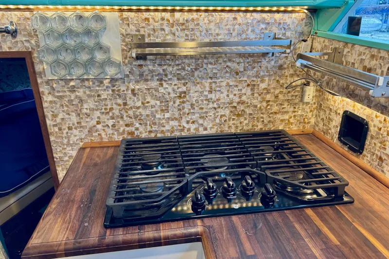 Slide: The Image of 1970 Chris-Craft Commander 42 kitchen with modern stove and mosaic backsplash. - 39