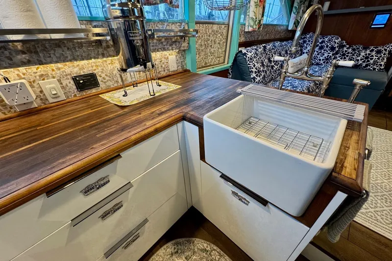 Slide: The Image of 1970 Chris-Craft Commander 42 kitchen with wooden countertops and farmhouse sink. - 41