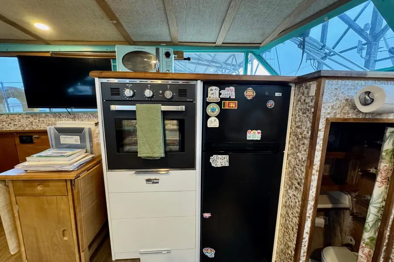 Slide: The Image of 1970 Chris-Craft Commander 42 interior with kitchen appliances and retro decor. - 42
